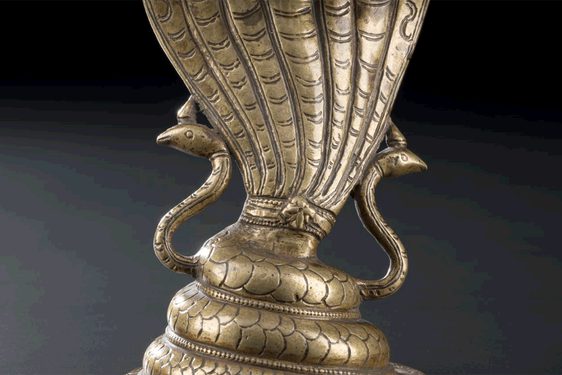 Figure of a seven-headed cobra in cast and chased brass.